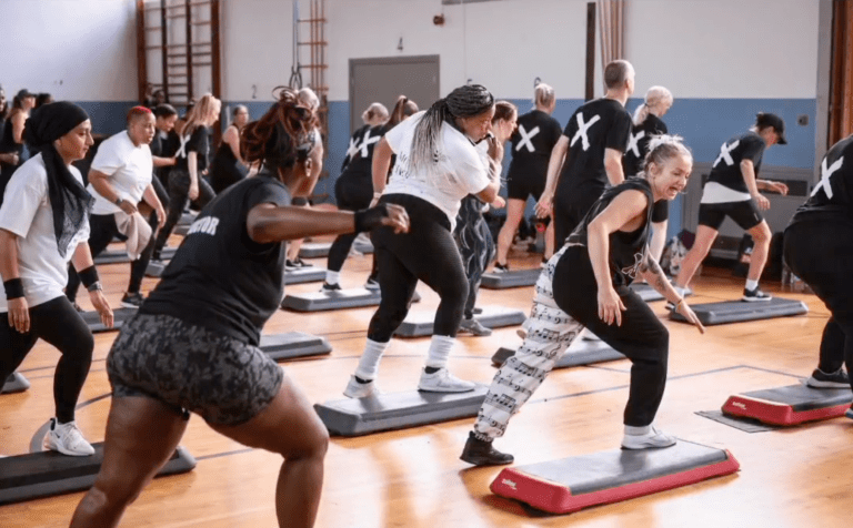 Women step aerobics workout class